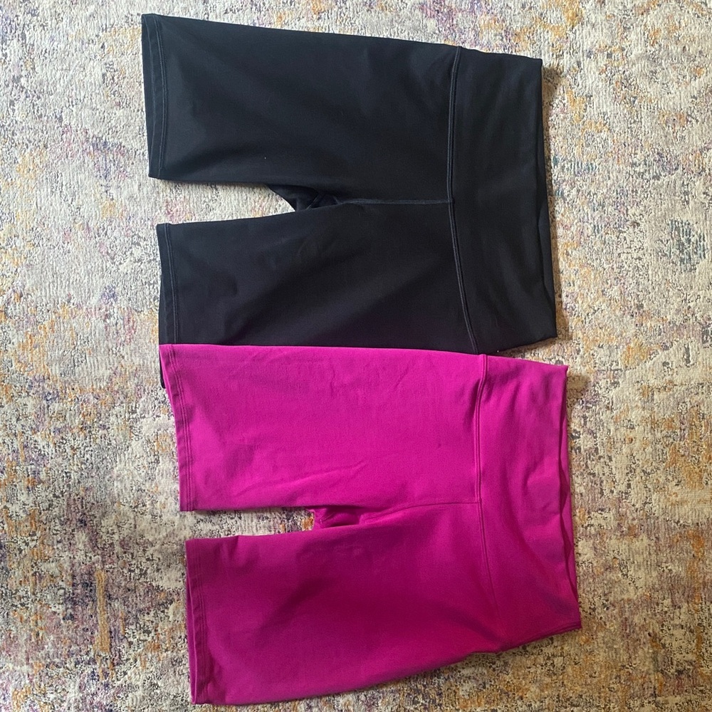 2 Pairs of Fabletics PowerHold 9 inch Stretch Bike Shorts Black and Fuchsia